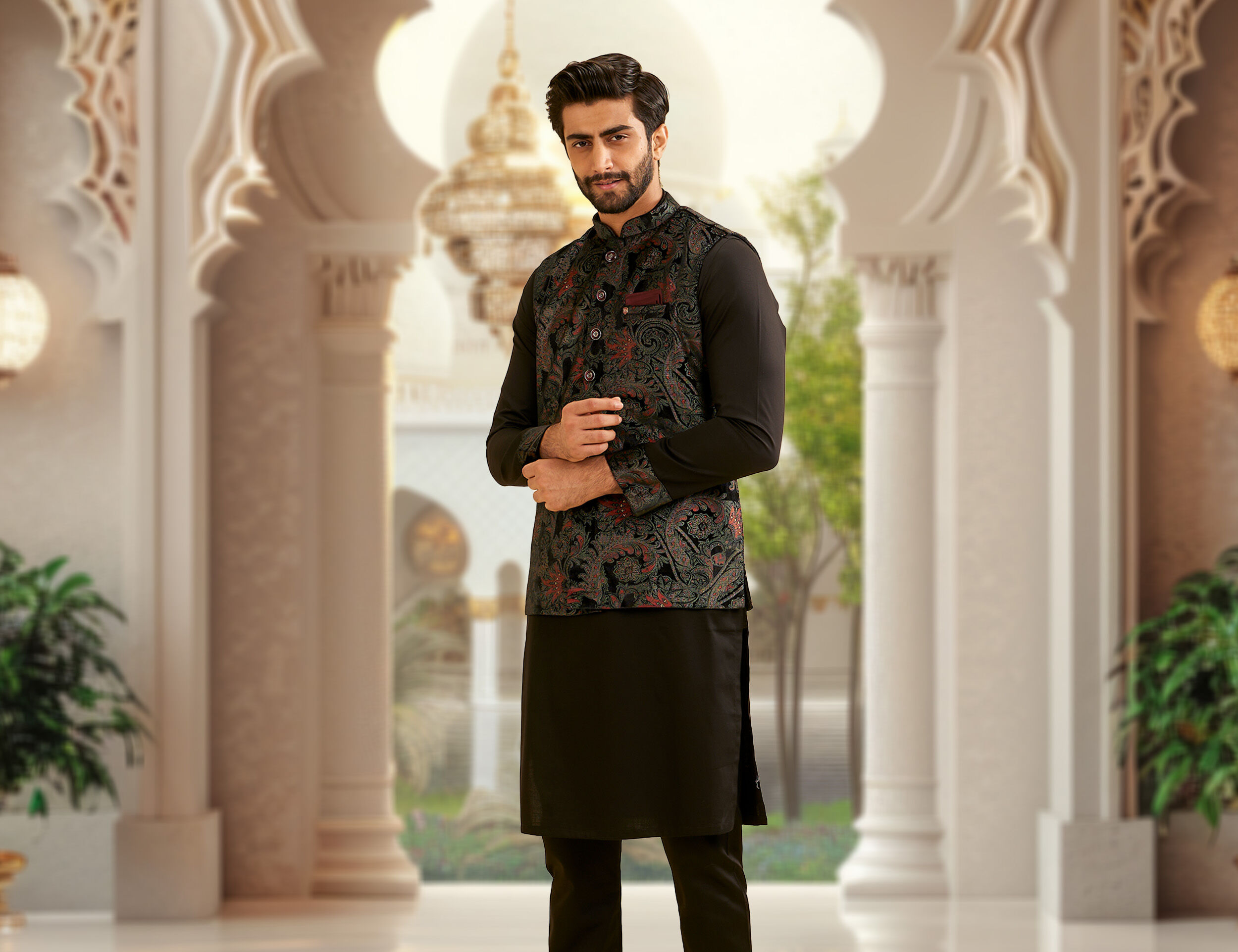 Man wearing a black kurta paired with a printed black jacket for a stylish wedding photoshoot